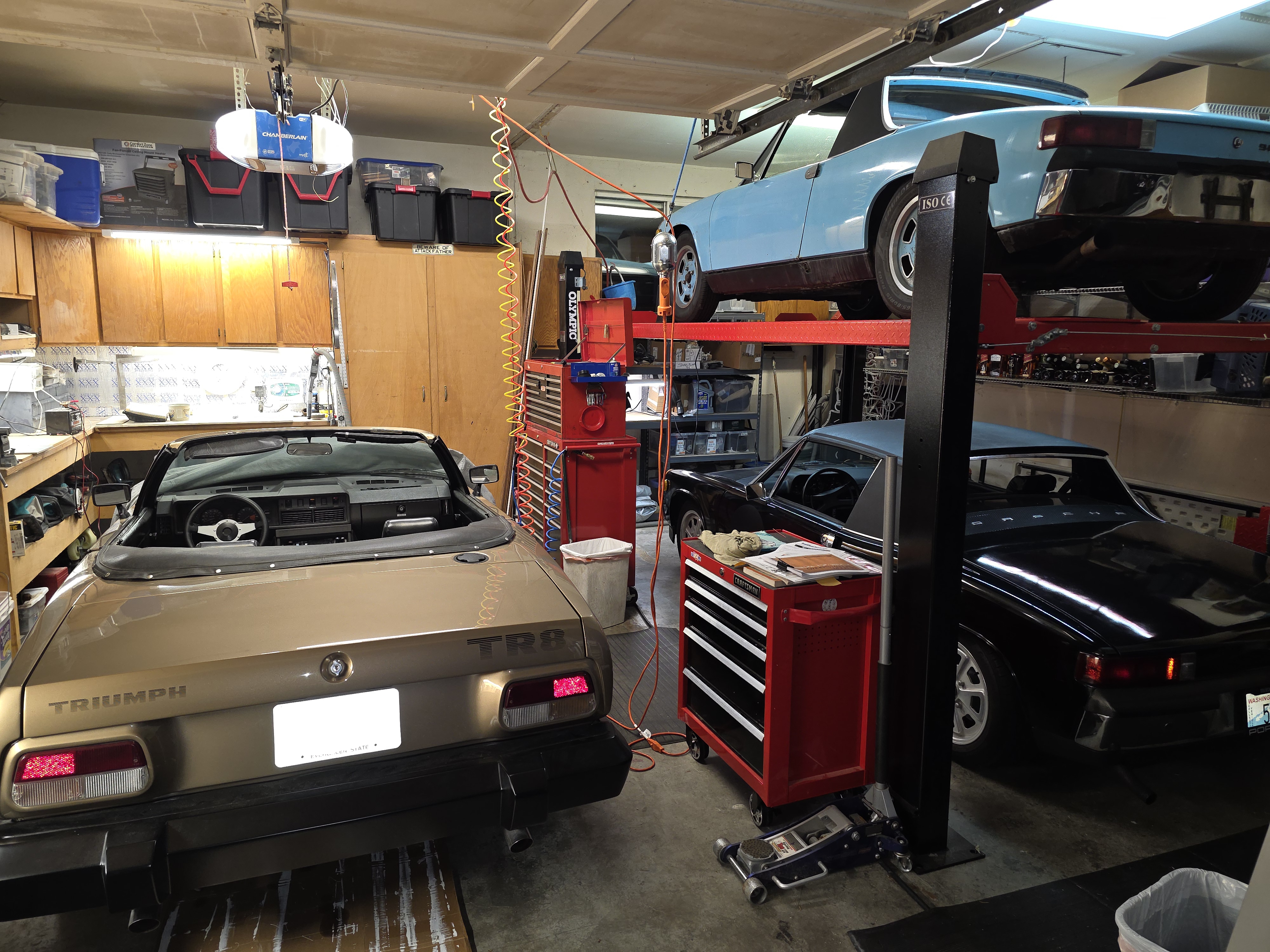 PSAD Garage featuring a Triumph TR8 and Porsche 914s